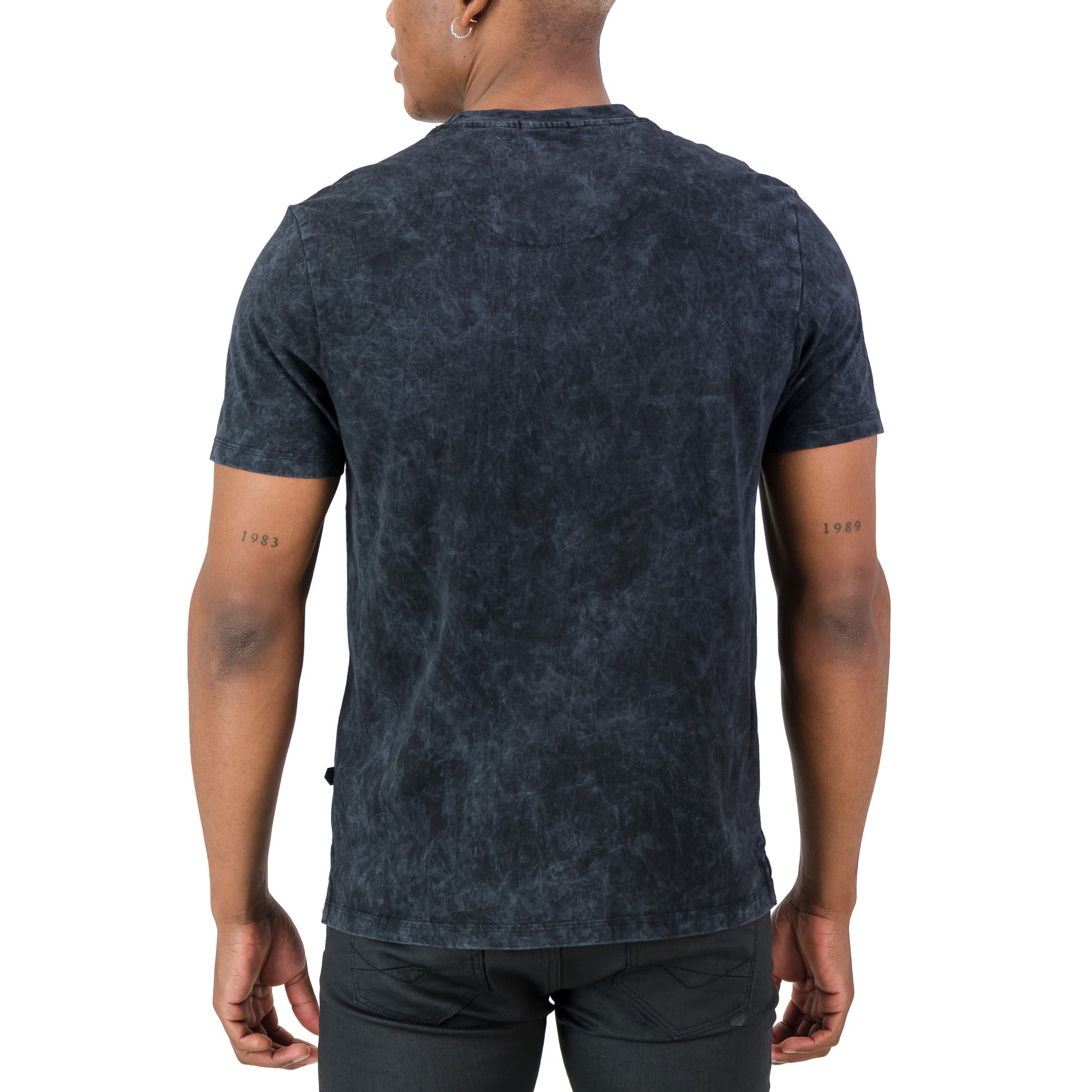 Model wearing the Rodgers Tee - Black from the back, showcasing the garment-washed texture and regular fit design.