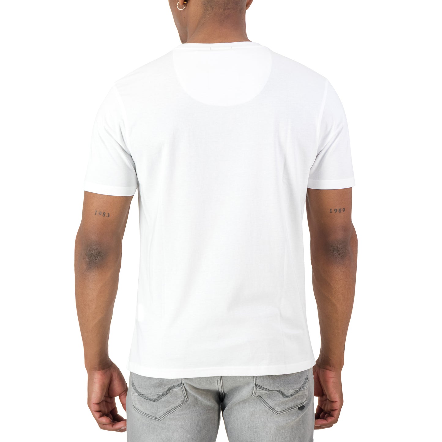 Back view of a model wearing the Surge Atlas Tee - White, showcasing its premium design and fit.