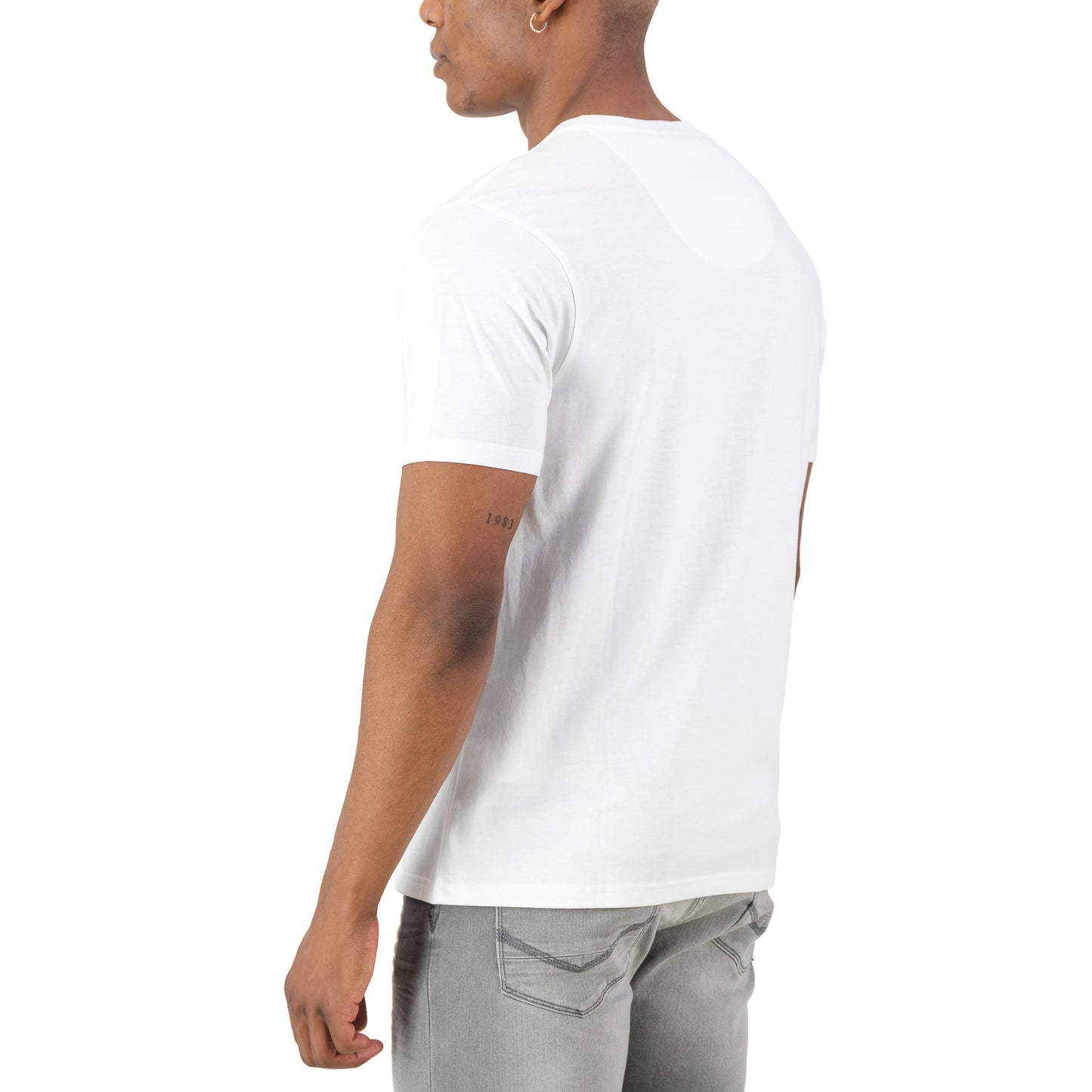 Back view of a man wearing the Surge Atlas Tee - White, showcasing a refined streetwear design and premium comfort.