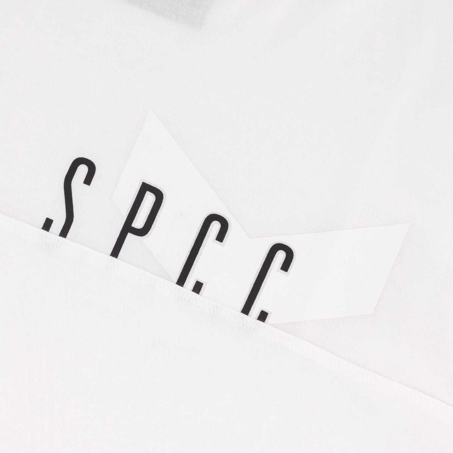 SPCC logo detail on the Surge Atlas Tee - White showcasing refined streetwear style and premium quality.