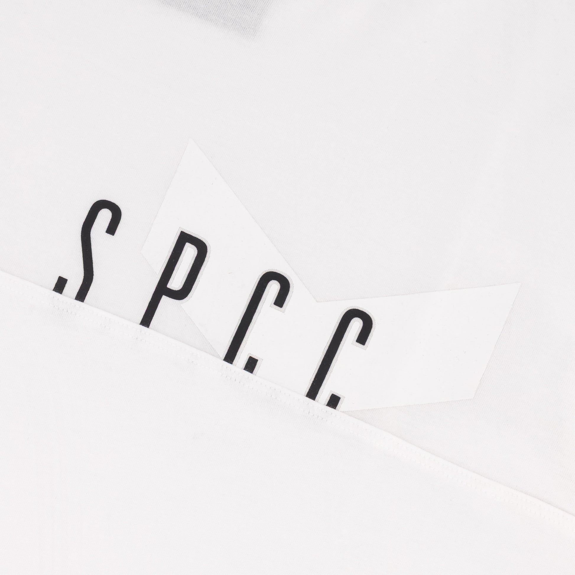 SPCC logo detail on the Surge Atlas Tee - White showcasing refined streetwear style and premium quality.