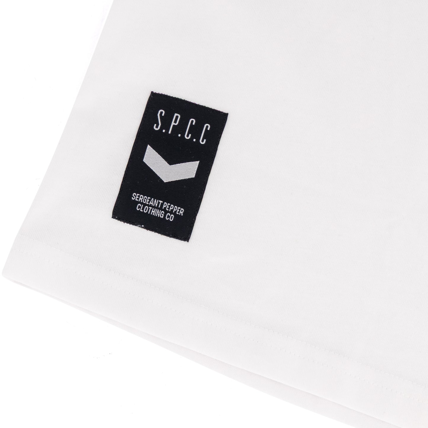Surge Atlas Tee - White with SPCC woven badge on cuff for stylish streetwear comfort.