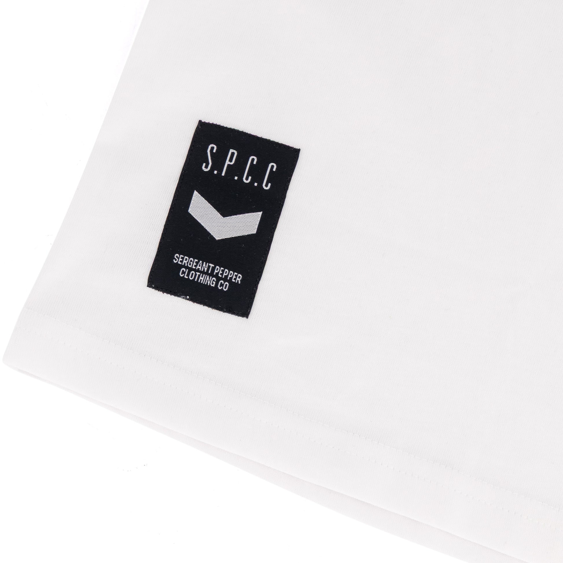 Surge Atlas Tee - White with SPCC woven badge on cuff for stylish streetwear comfort.
