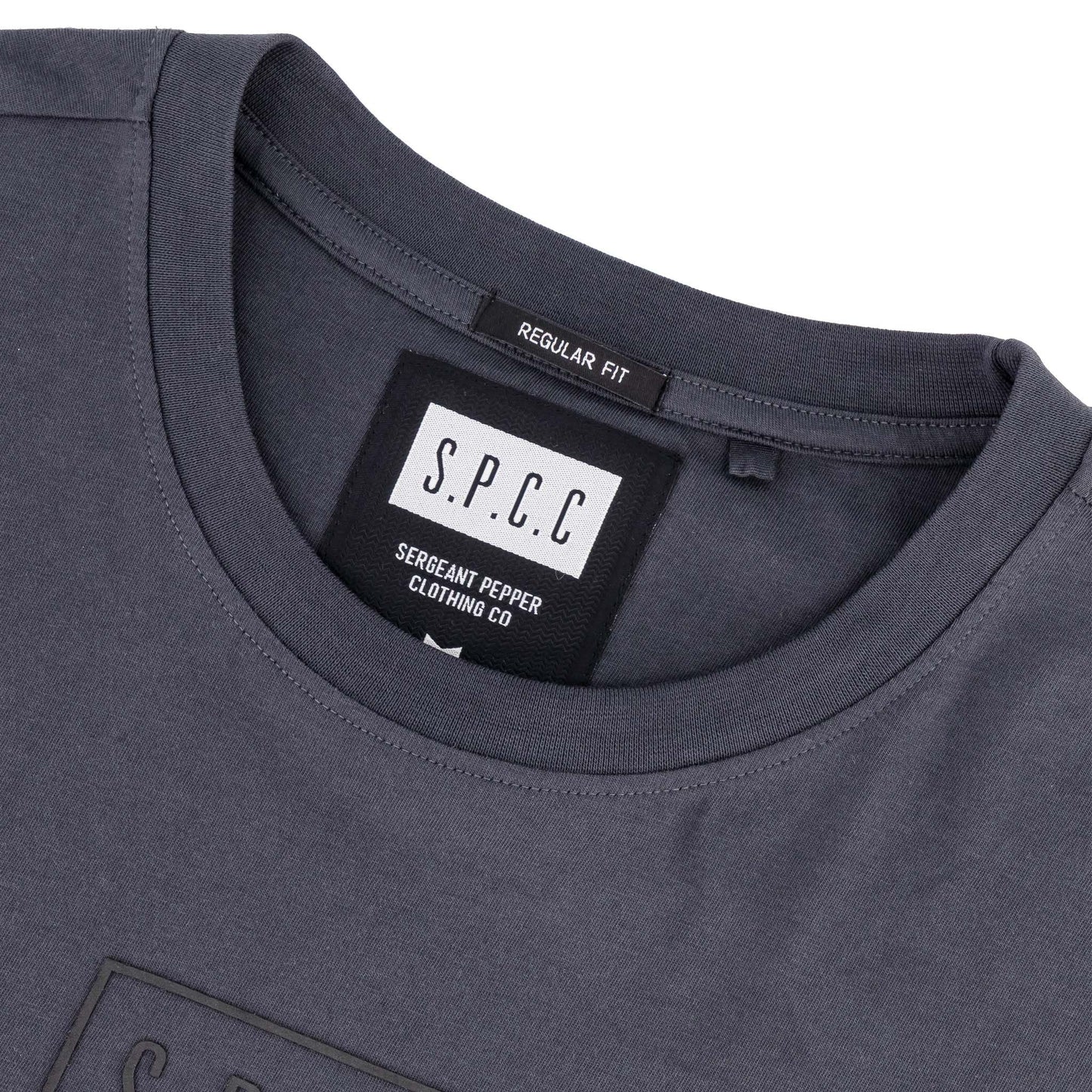 Rhett Tee - Charcoal close-up showing SPCC label, highlighting its regular fit and quality craftsmanship.