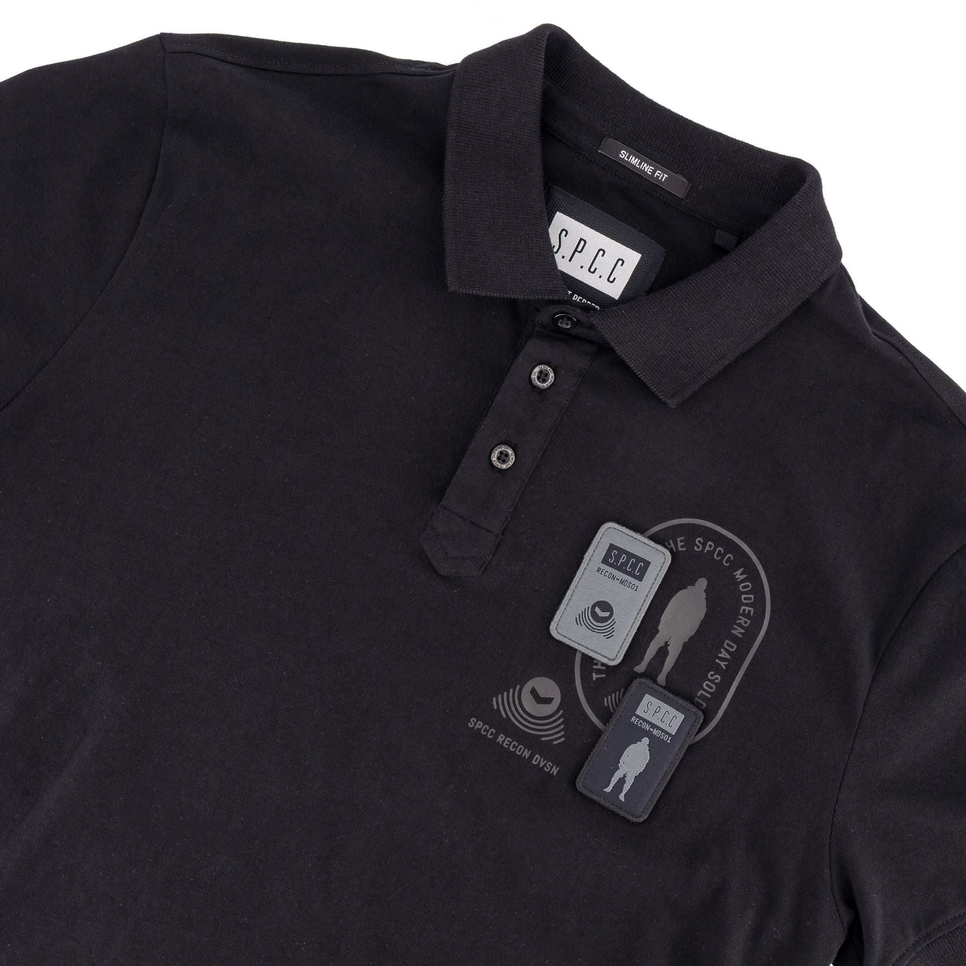 Recon Escalade Golfer  - Black polo shirt featuring SPCC badge and print detail.
