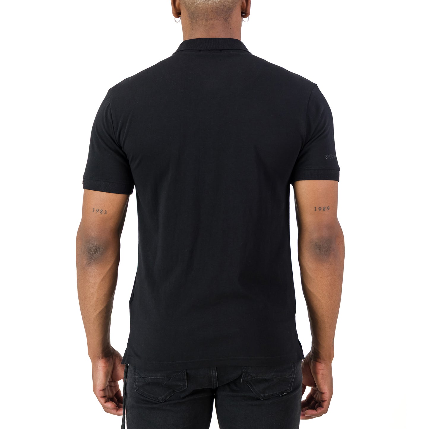 Back view of a man wearing the Recon Escalade Golfer - Black, showcasing its knitted collar and cuff.
