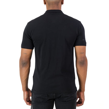 Back view of a man wearing the Recon Escalade Golfer - Black, showcasing its knitted collar and cuff.