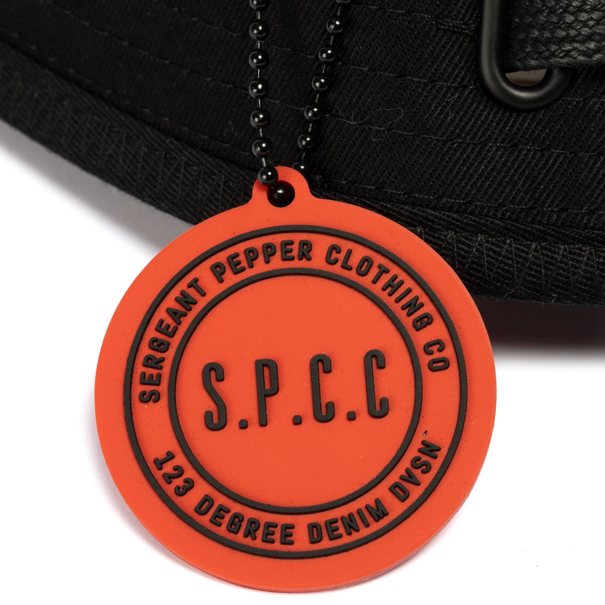 Surge Atlas Bucket Hat - Black detail featuring SPCC rubber badge and chain for urban style and functionality.