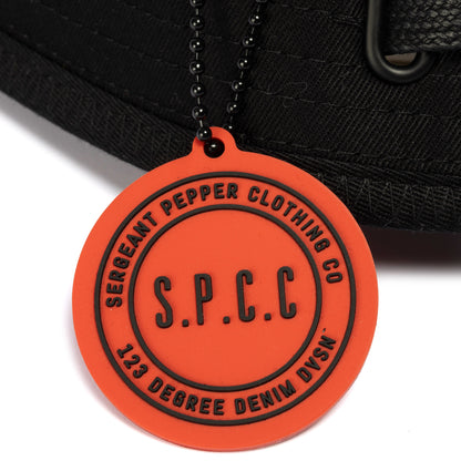 Surge Atlas Bucket Hat - Black detail featuring SPCC rubber badge and chain for urban style and functionality.