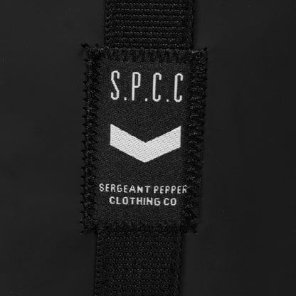 Label showcasing S.P.C.C. logo on the Surge Atlas Hip Bag - Black, highlighting its stylish branding.