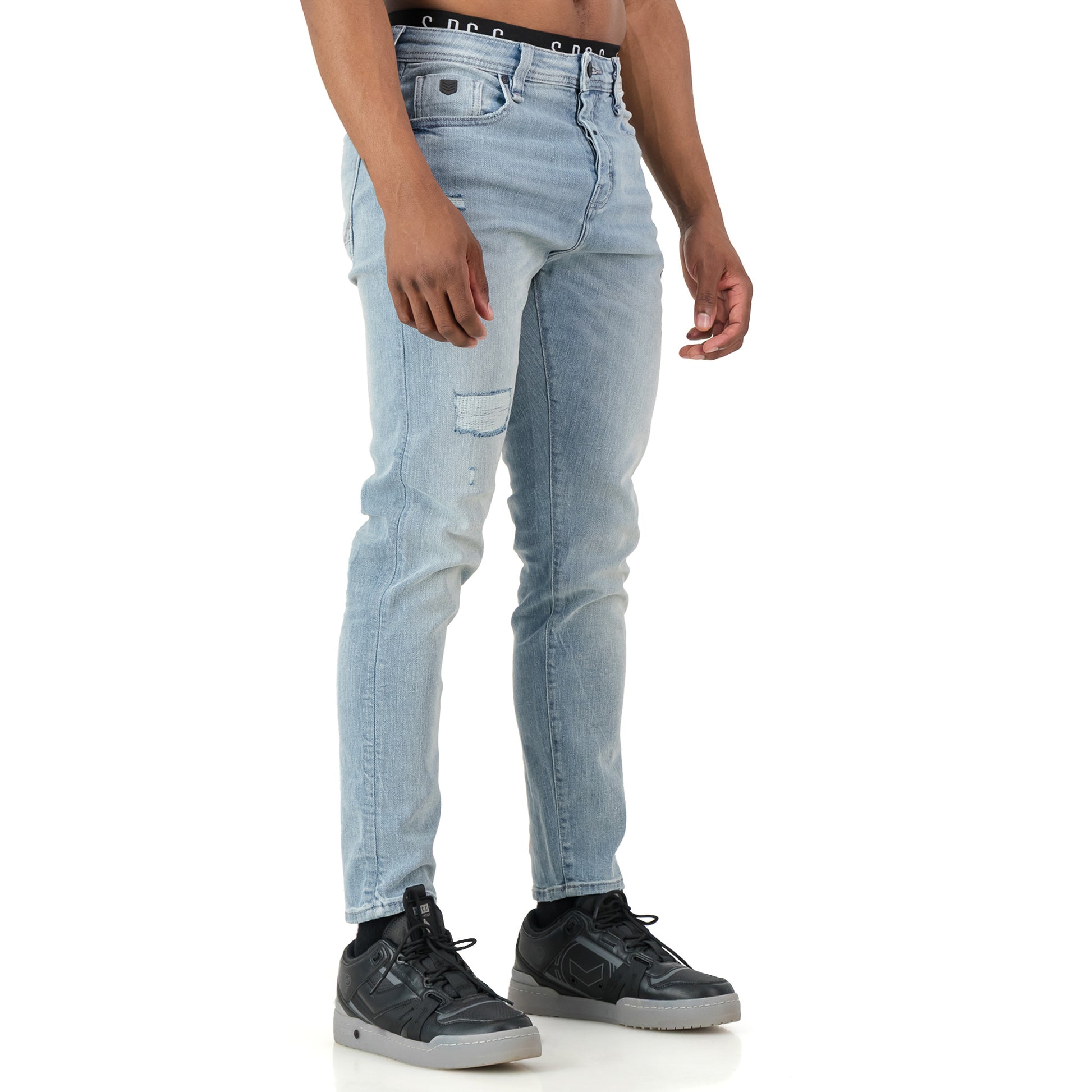 Typhoon Jeans - Bleach worn by a model, showcasing the stylish bleach wash and rugged design.
