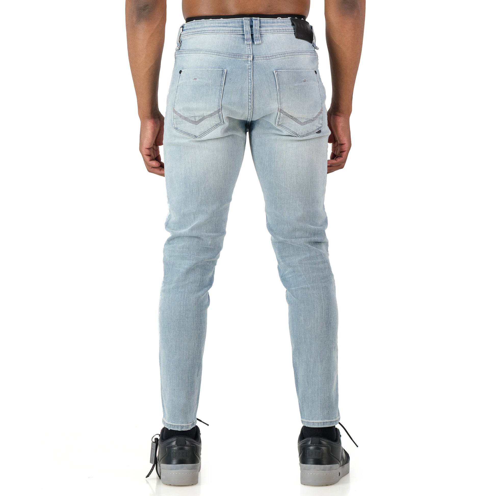 Typhoon Jeans  - Bleach shown from the back, featuring a fitted silhouette and heavy bleach wash for a worn-in look.