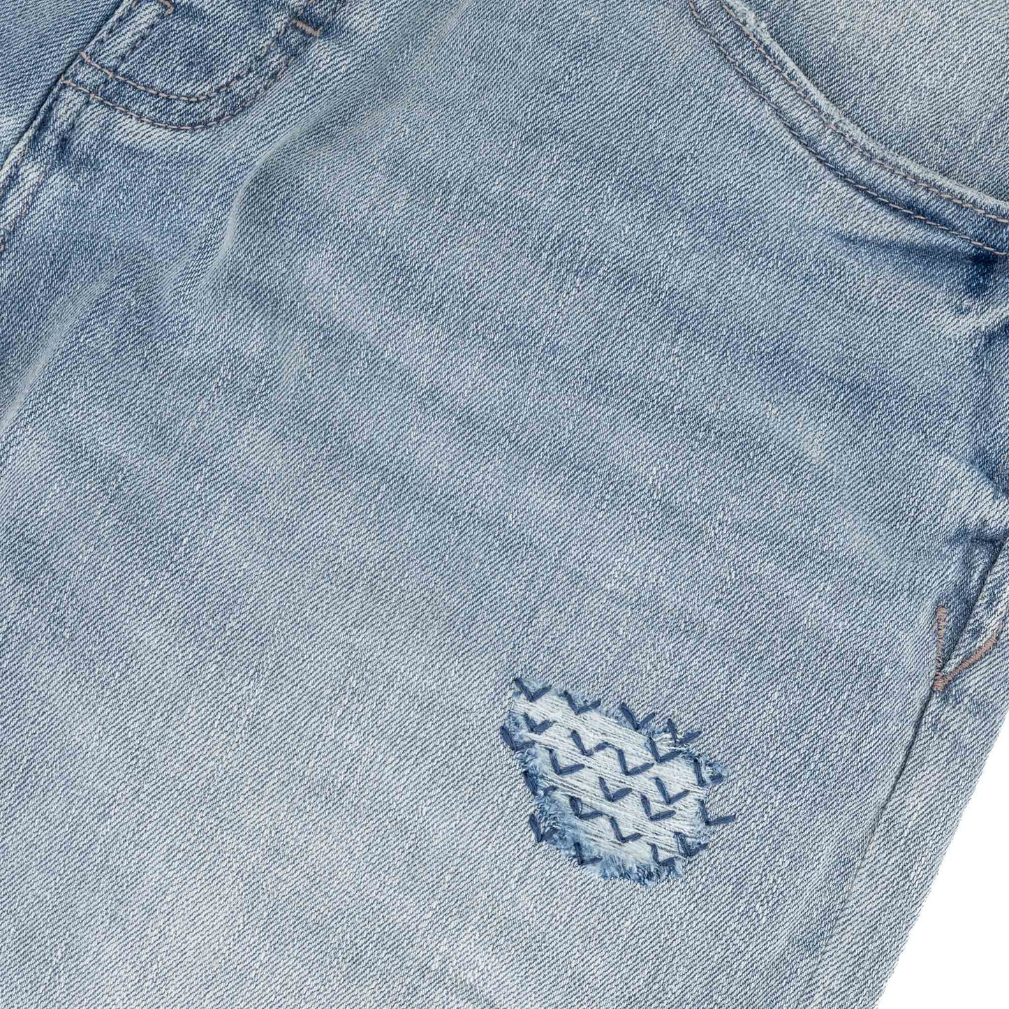 Typhoon Jeans - Bleach close-up of the embroidered detail on durable denim in a heavy bleach wash.
