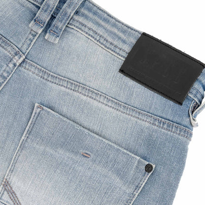 Typhoon Jeans - Bleach back pocket and branded leather tag, showcasing heavy bleach wash denim texture.