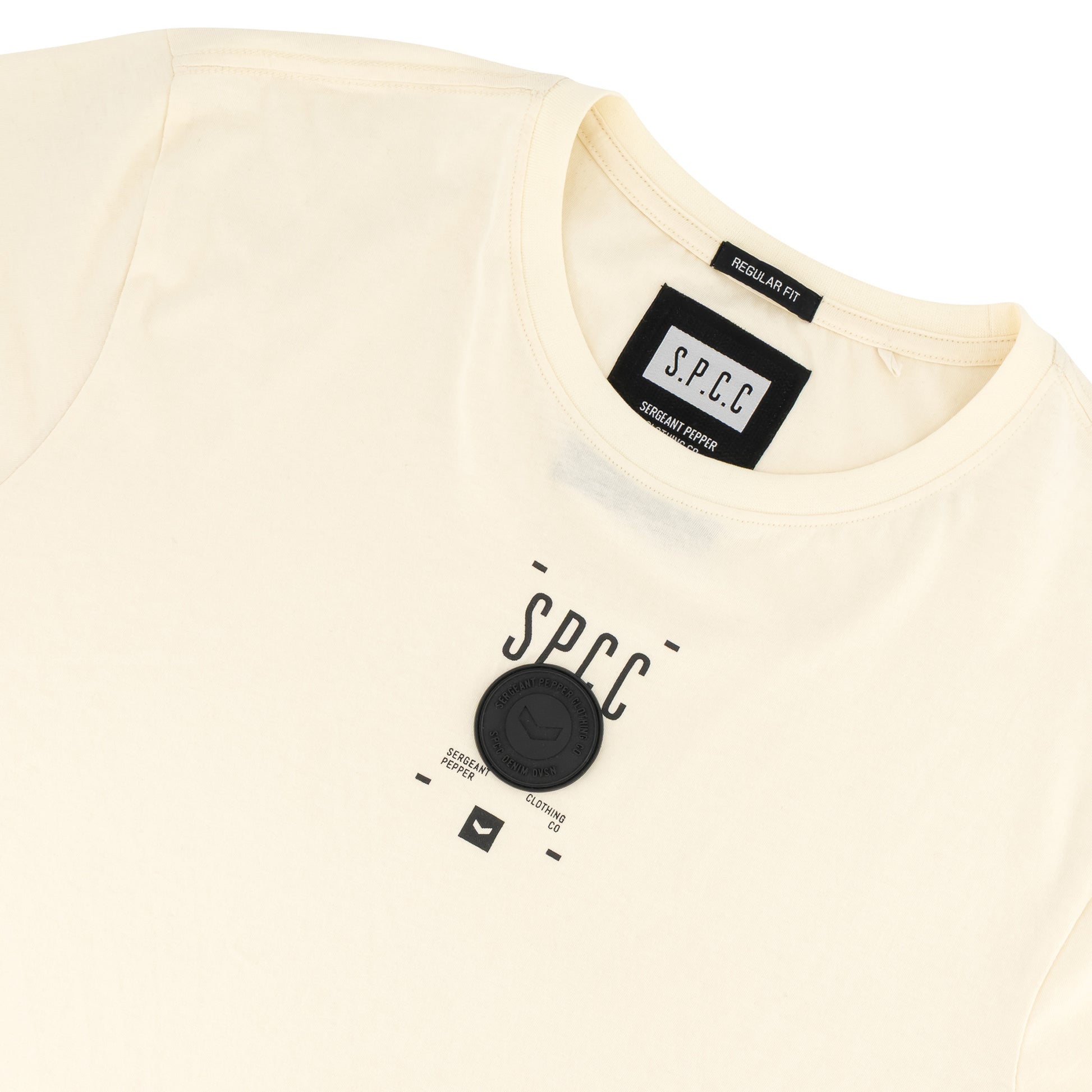 Romain Tee - Off White featuring SPCC print and badge on soft-touch fabric, showcasing streetwear style.