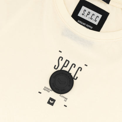 Romain Tee - Off White with SPCC print and badge detail, showcasing a streetwear-inspired design.